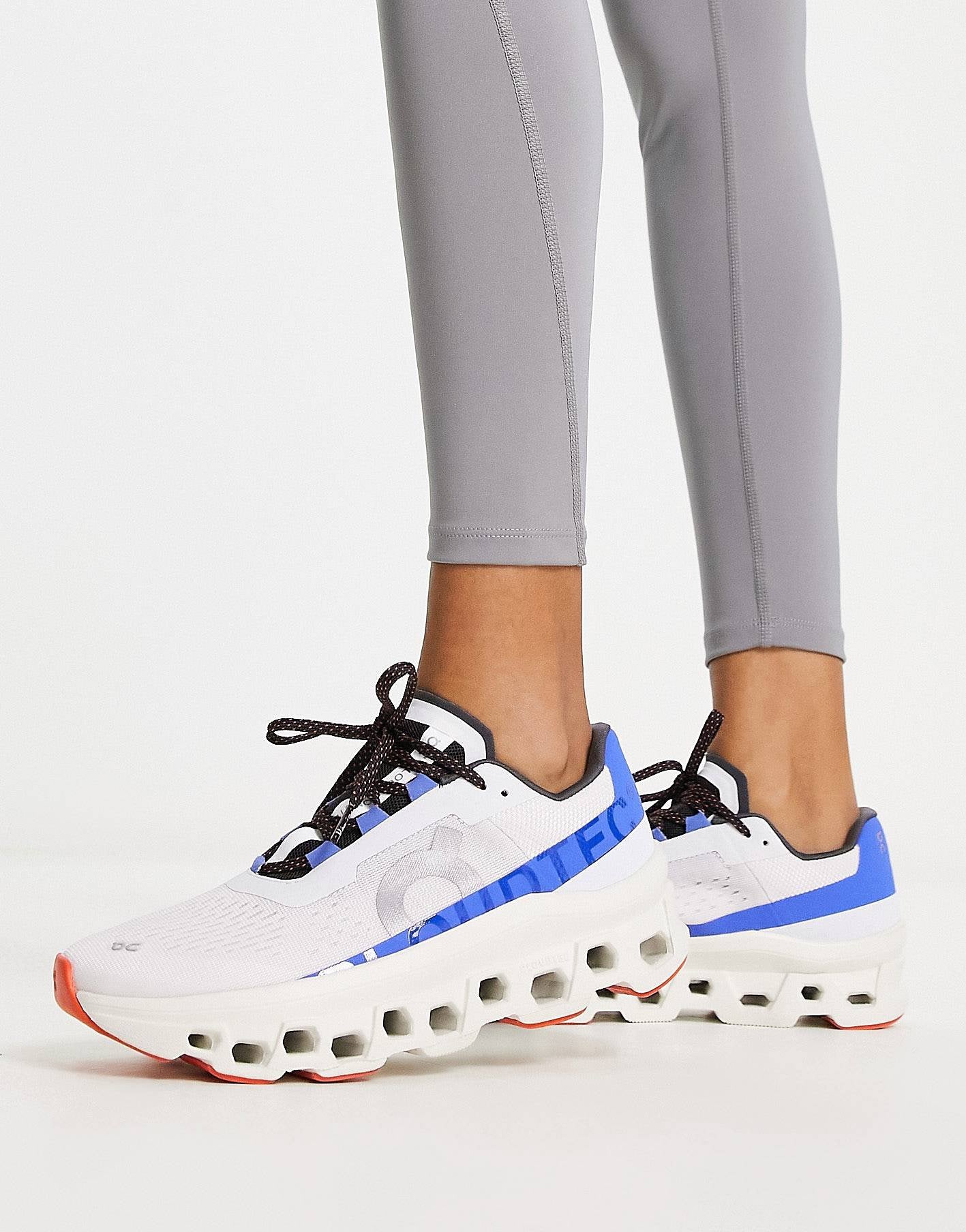 On Running Cloudmonster trainers in white and cobalt