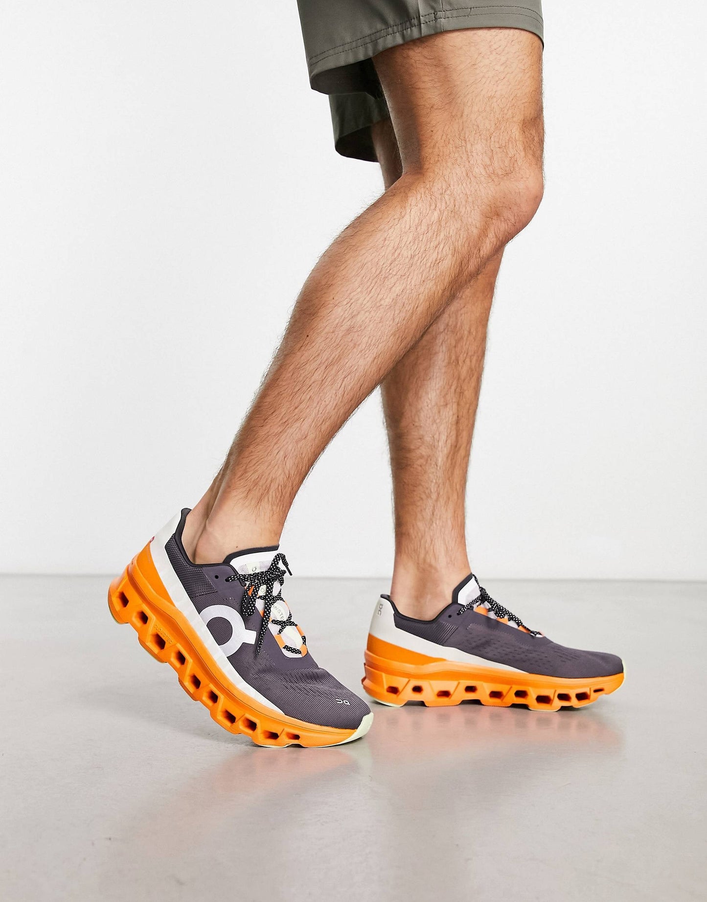 On Running Cloudmonster trainers in grey and orange