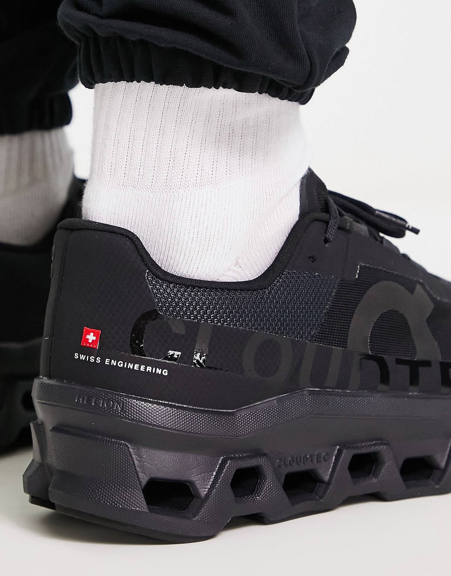 On Running Cloudmonster trainers in all black